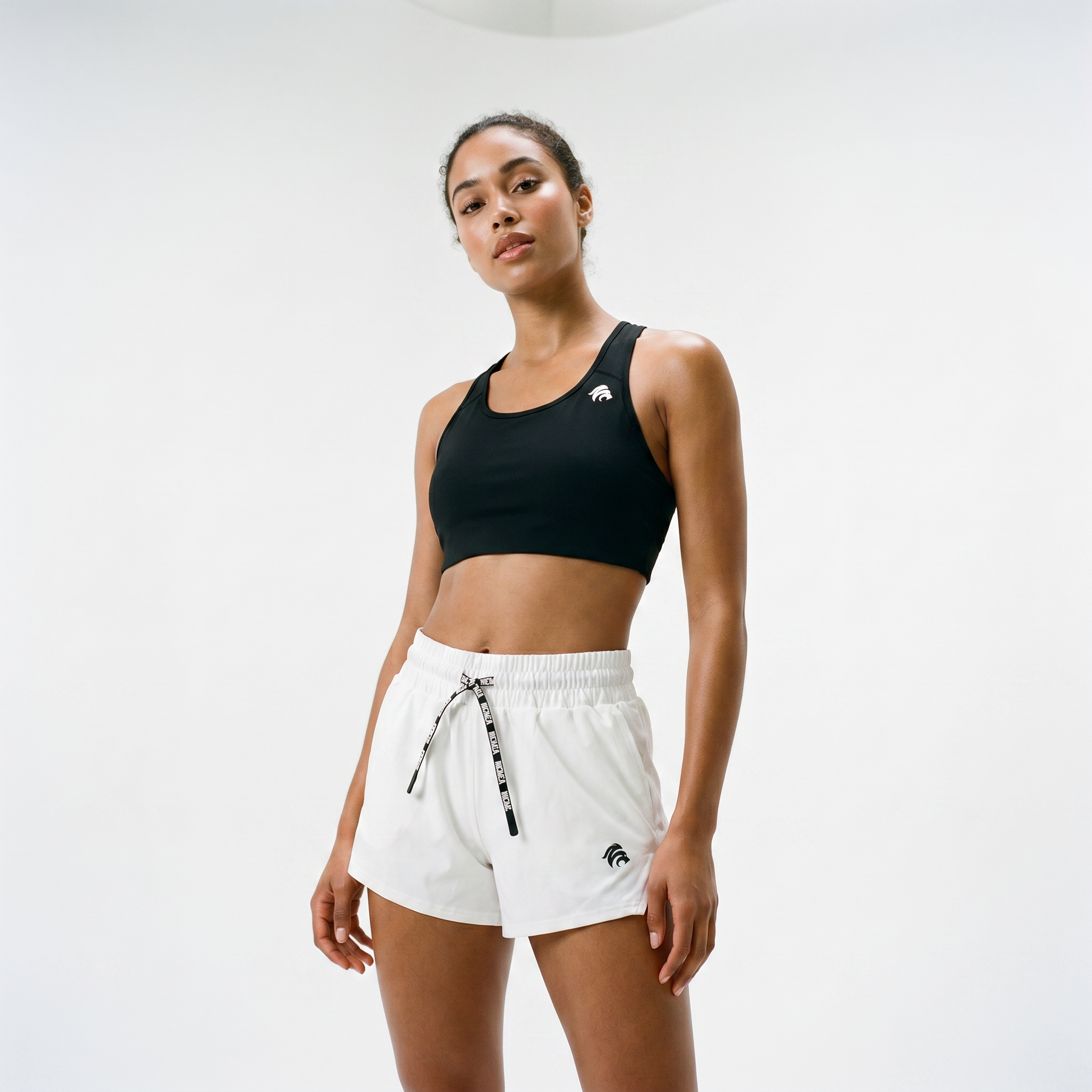 Generated_with_Kive.ai_-_can_you_have_a_young_athletic_beautiful_mixed_woman_modeling_the_sports_bra_and_these_shorts_for_an_activewear_brand_in_a_white_backgroung_studio_that_s_a_hig.png