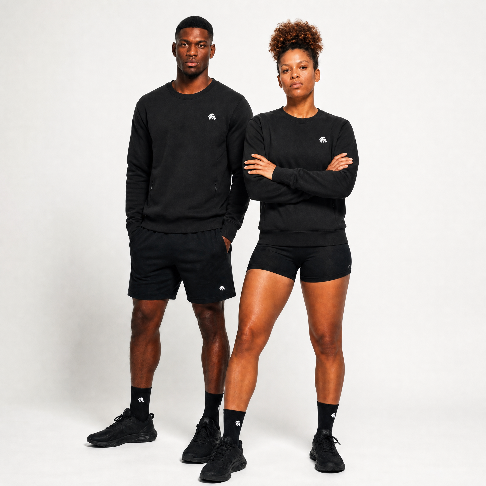 Generated_with_Kive.ai_-_can_you_have_this_woman_and_man_both_modeling_this_black_crewneck_sweatshirt_for_an_activewear_brand_in_a_white_backgroung_studio_that_s_a_high_professional_p.png