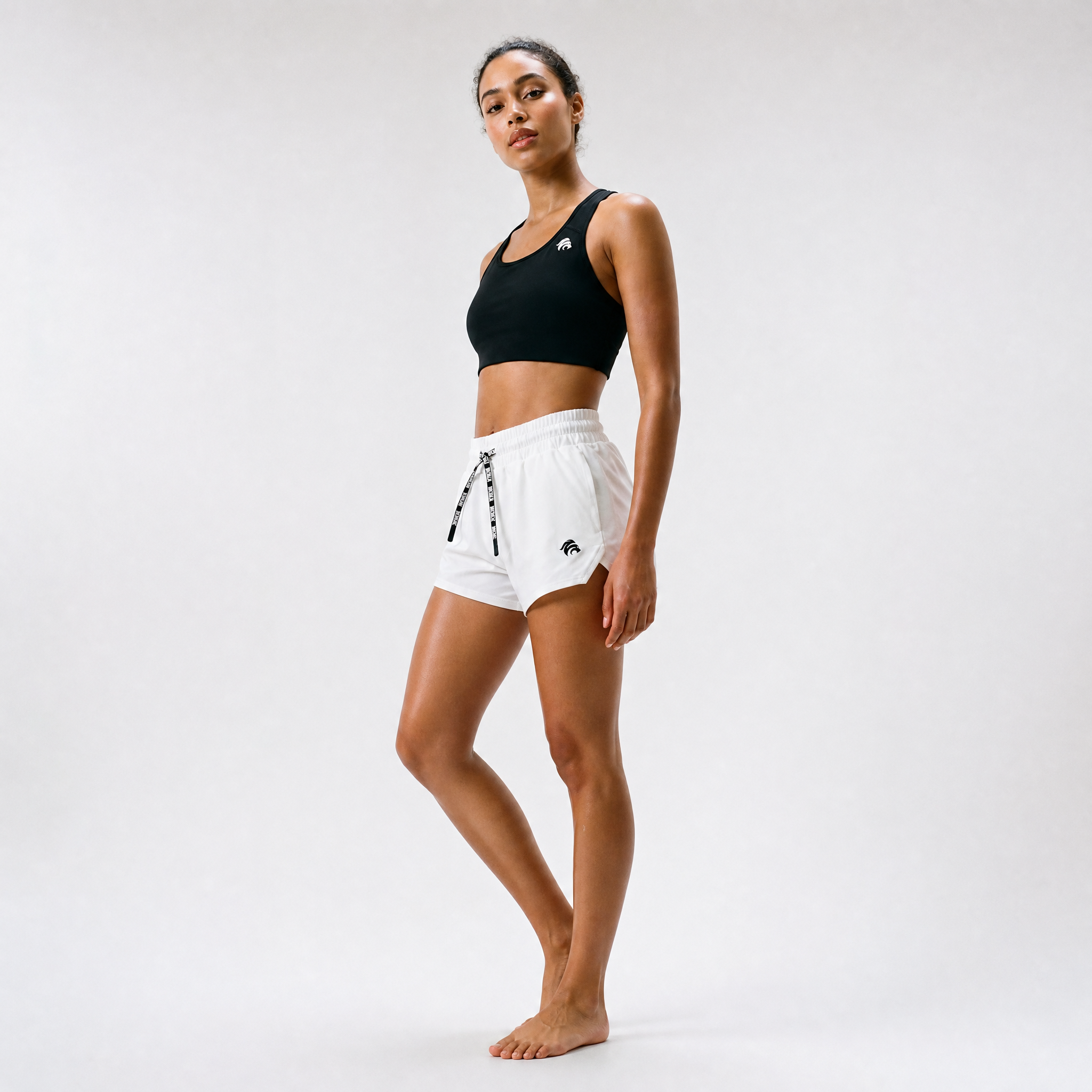 Generated_with_Kive.ai_-_can_you_have_this_woman_modeling_at_a_side_angle_the_sports_bra_and_these_shorts_for_an_activewear_brand_in_a_white_backgroung_studio_that_s_a_high_profession.png